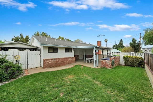 4423 N Sunflower Ave, Covina, CA 91724 - rear view of property with a fenced backyard, brick siding, a patio, and a lawn