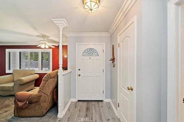 4423 N Sunflower Ave, Covina, CA 91724 - foyer entrance with light wood finished floors, a ceiling fan, ornamental molding, baseboards, and decorative columns