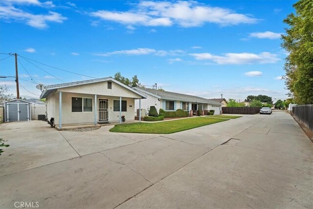4423 N Sunflower Ave, Covina, CA 91724 - view of front facade with a storage unit, driveway, a front yard, and fence