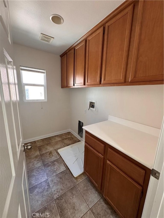 clothes washing area featuring baseboards, light tile patterned floors, hookup for a washing machine, visible vents, and cabinet space