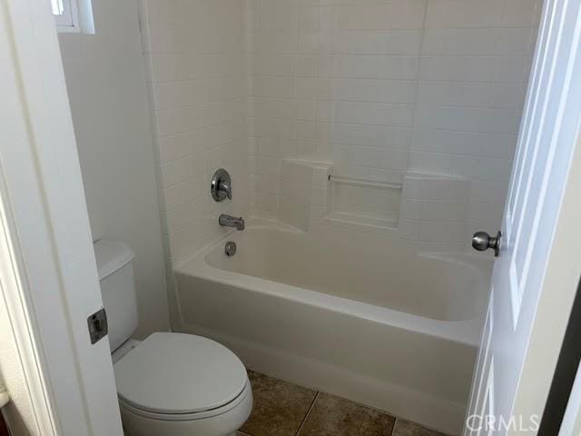 full bath with toilet,  shower combination, and tile patterned floors