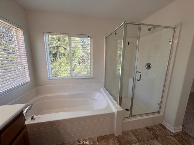 full bath with a stall shower, a garden tub, and plenty of natural light