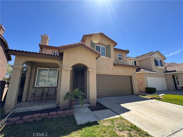 mediterranean / spanish house featuring concrete driveway, a porch, stucco siding, and a garage