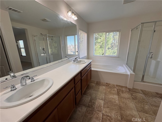 bathroom featuring a wealth of natural light, visible vents, and a sink