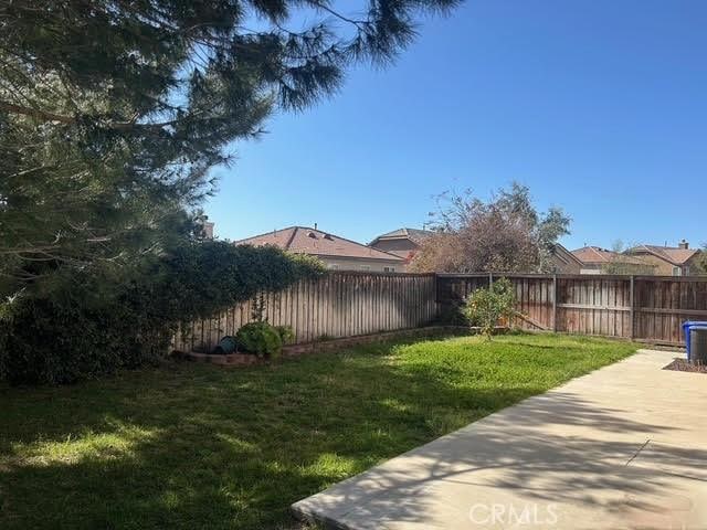 view of yard with a patio area and a fenced backyard