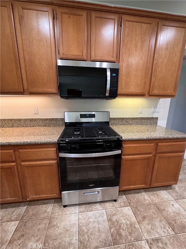 kitchen featuring stainless steel appliances and brown cabinetry