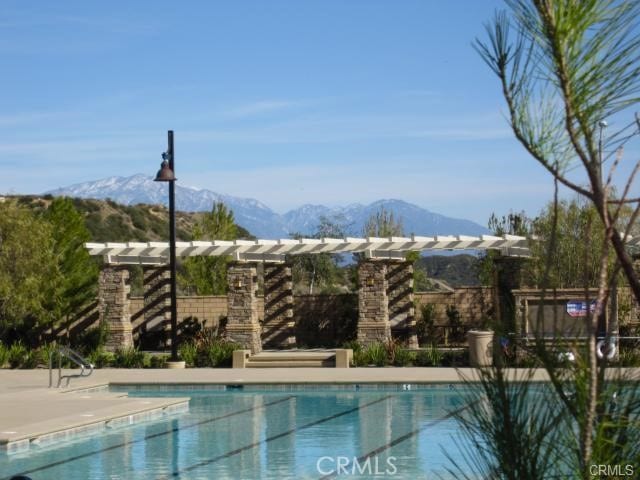 pool featuring a pergola and a mountain view