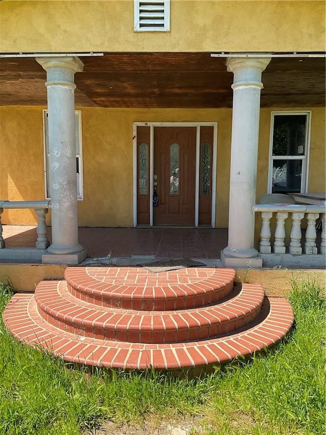 1134 4th Ave, Corning, CA 96021 - entrance to property with a porch, visible vents, and stucco siding