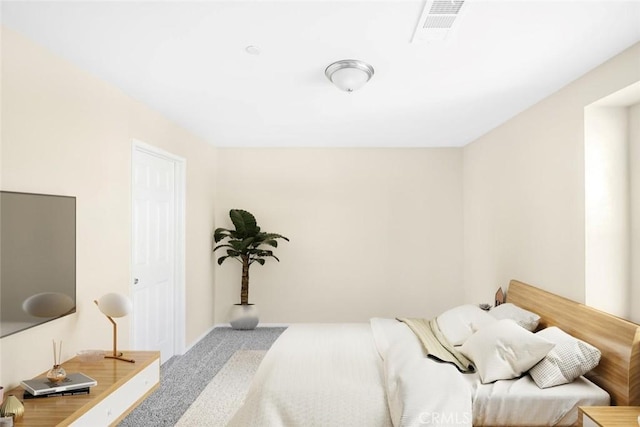 carpeted bedroom featuring visible vents