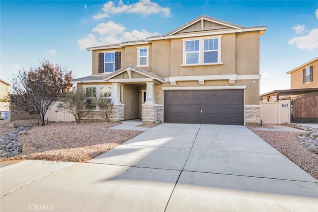 craftsman-style home featuring stucco siding, an attached garage, driveway, and stone siding