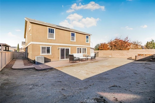 back of property with a fenced backyard, central AC unit, outdoor lounge area, a patio area, and stucco siding