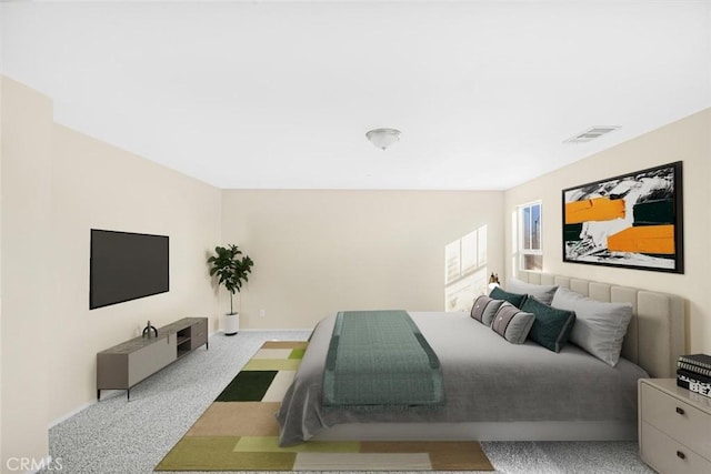 carpeted bedroom with visible vents and baseboards