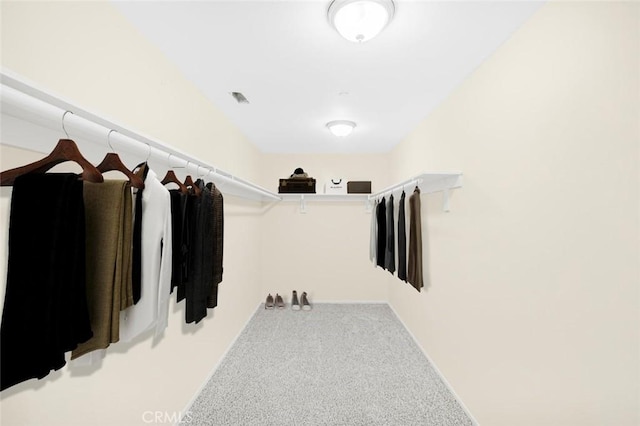 walk in closet featuring visible vents and carpet flooring
