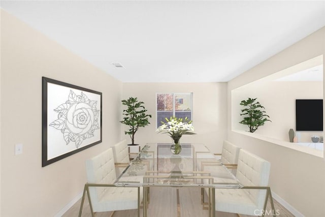 dining space with baseboards and visible vents