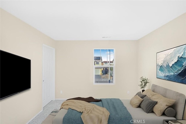 carpeted bedroom with baseboards and visible vents