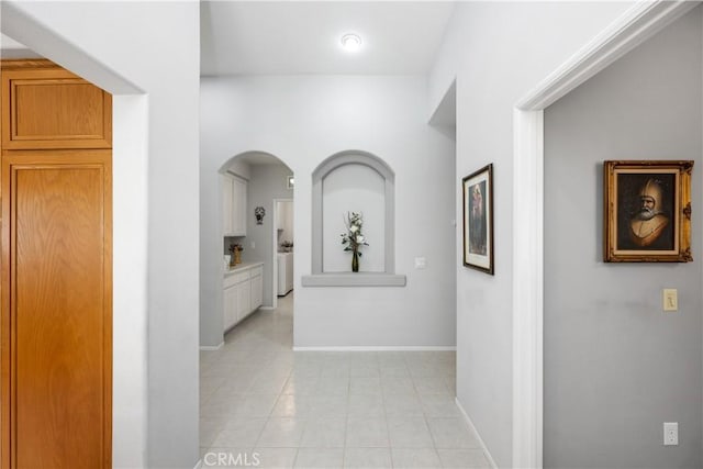 40310 Via Tonada, Murrieta, CA 92562 - corridor with washer / dryer, baseboards, and light tile patterned flooring