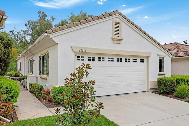 40310 Via Tonada, Murrieta, CA 92562 - view of home's exterior featuring a garage, a tile roof, driveway, and stucco siding