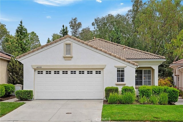 40310 Via Tonada, Murrieta, CA 92562 - view of front of house with stucco siding, driveway, a tiled roof, and a garage