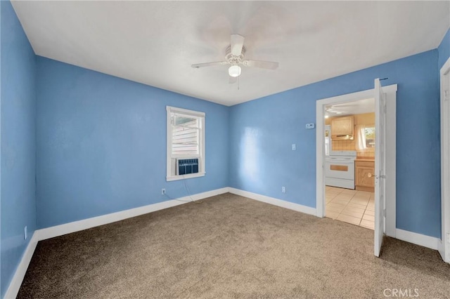 unfurnished bedroom featuring ceiling fan, carpet, and baseboards