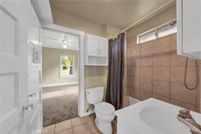 full bath featuring toilet, a sink, ceiling fan, and tile patterned floors