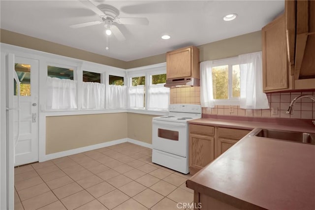 kitchen with decorative backsplash, white electric stove, under cabinet range hood, a sink, and a ceiling fan