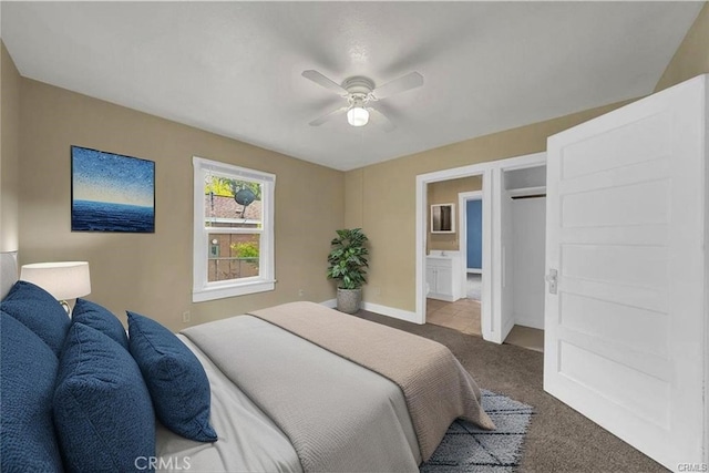 bedroom with ceiling fan, dark carpet, and baseboards
