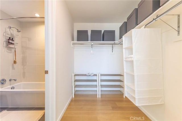 walk in closet featuring light wood finished floors