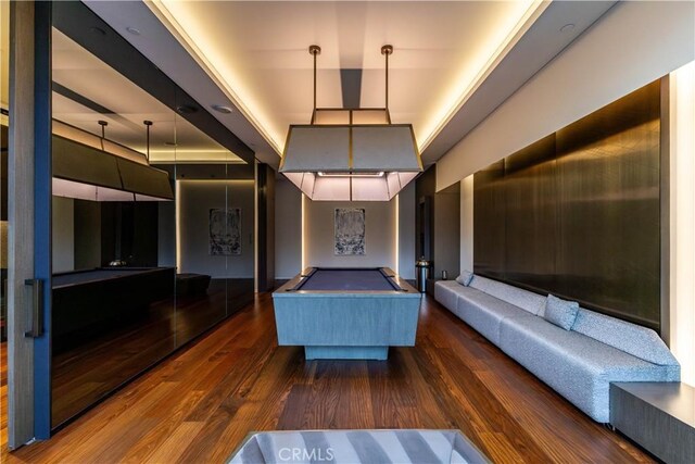 unfurnished bedroom with dark wood-style floors and pool table