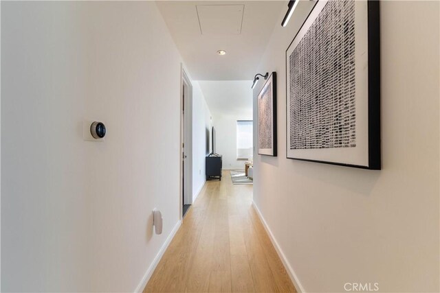 corridor with attic access, recessed lighting, baseboards, and light wood-type flooring