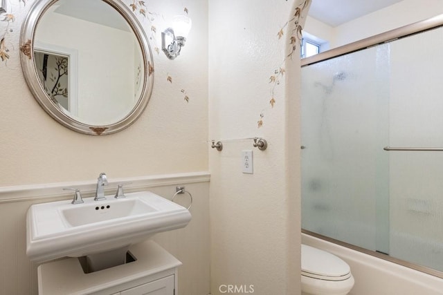 29827 Via Sevilla, Temecula, CA 92591 - full bathroom featuring wainscoting, a sink, shower / bath combination with glass door, and toilet