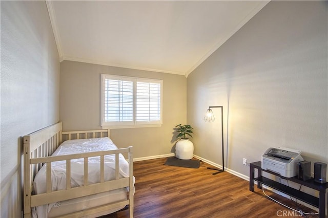 bedroom with ornamental molding, vaulted ceiling, wood finished floors, and baseboards