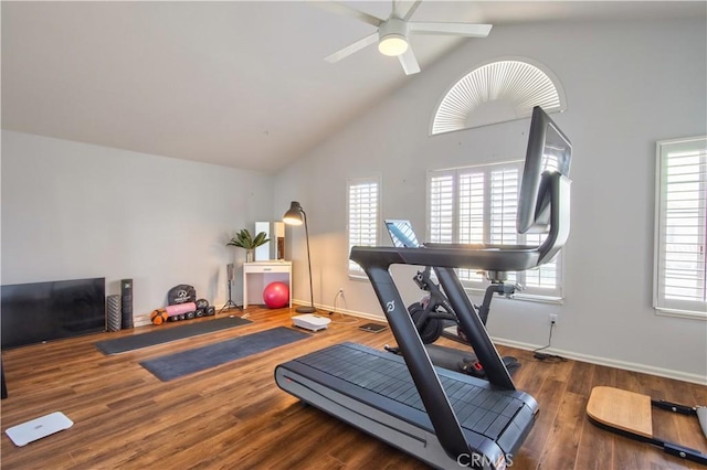 exercise room featuring a ceiling fan, wood finished floors, baseboards, and high vaulted ceiling