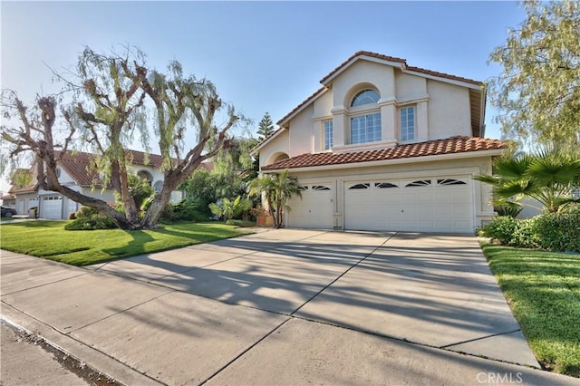 mediterranean / spanish house featuring driveway, a tiled roof, an attached garage, and stucco siding
