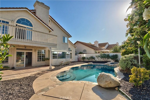 view of pool with a fenced backyard, a patio, and a pool with connected hot tub