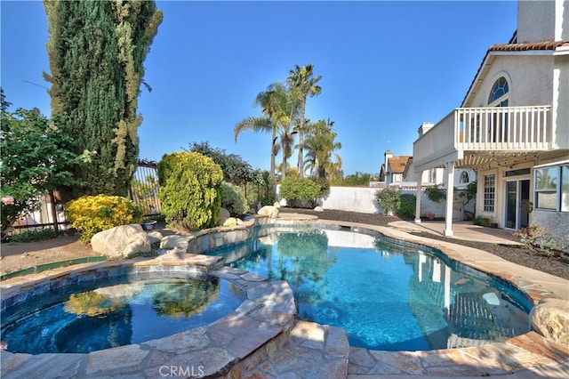 view of pool featuring a fenced backyard, a patio area, and a pool with connected hot tub