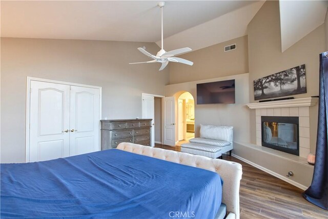 31384 Corte Tunas, Temecula, CA 92592 - bedroom with wood finished floors, a fireplace, high vaulted ceiling, arched walkways, and baseboards