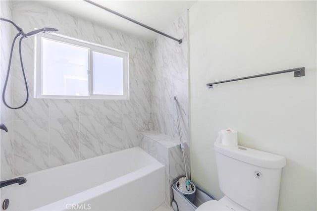 bathroom featuring bathtub / shower combination and toilet