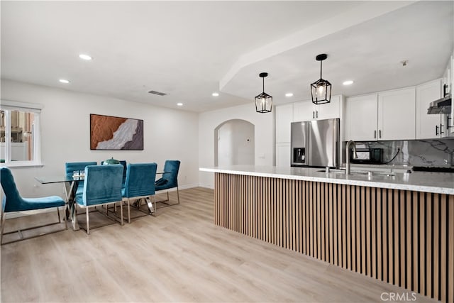 kitchen with stainless steel fridge, recessed lighting, and visible vents