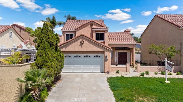 mediterranean / spanish home with fence, an attached garage, stucco siding, concrete driveway, and a tiled roof