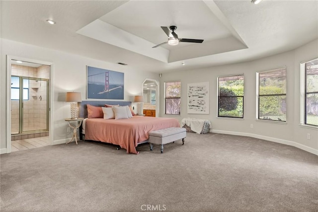 bedroom featuring baseboards, carpet flooring, and a tray ceiling