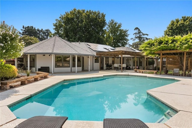pool with a pergola and a patio area