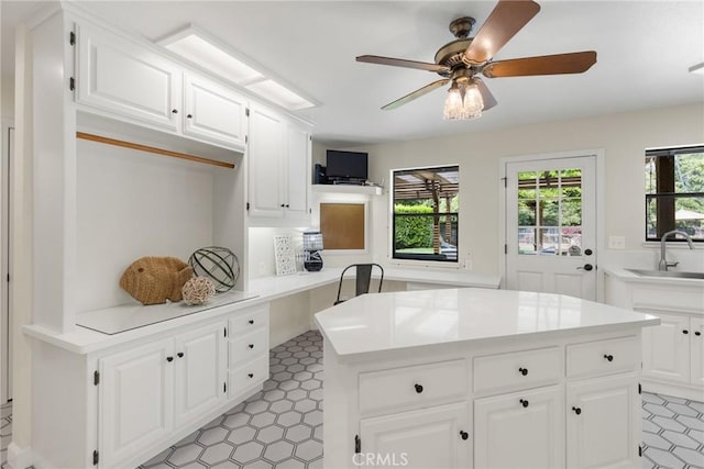 650 Crimson Ct, Chico, CA 95973 - kitchen with a sink, light countertops, a kitchen island, ceiling fan, and white cabinets