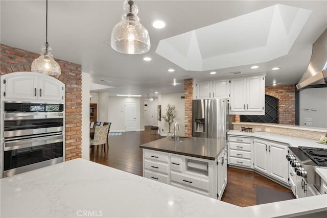 kitchen featuring recessed lighting, white cabinetry, decorative backsplash, dark wood-type flooring, and appliances with stainless steel finishes