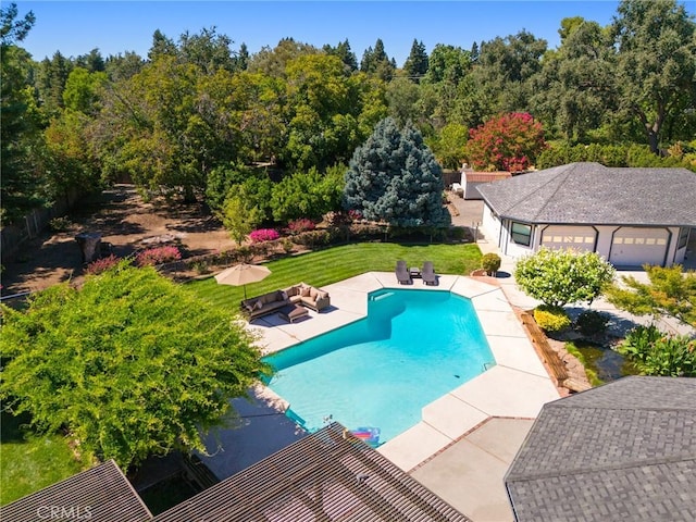 outdoor pool featuring a yard and a patio