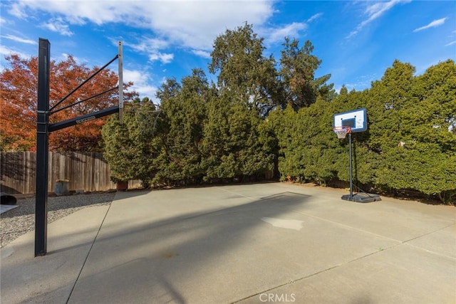 view of basketball court featuring basketball court and fence