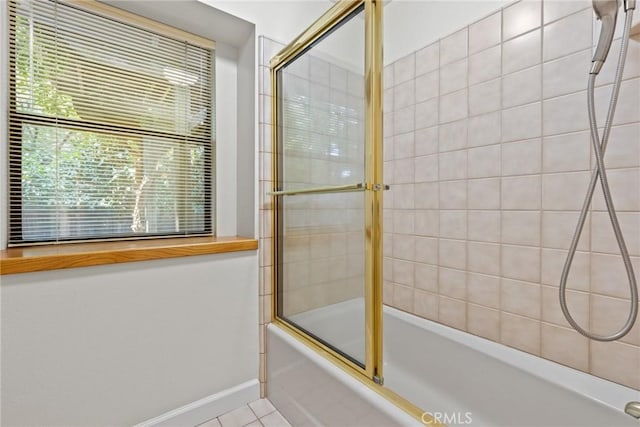 bathroom featuring baseboards, tile patterned flooring, and combined bath / shower with glass door