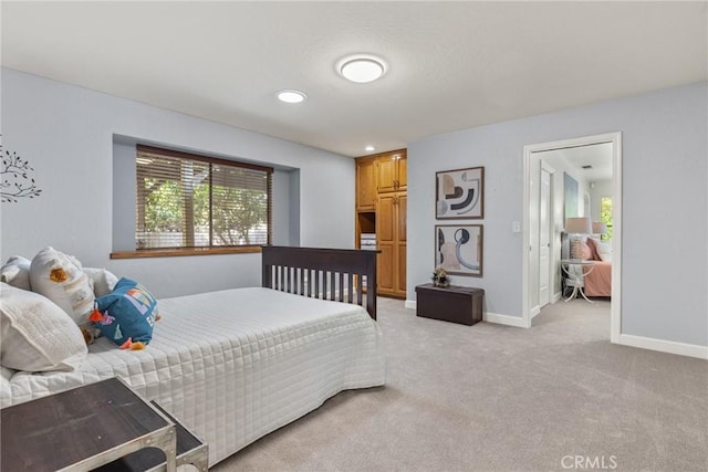 bedroom featuring recessed lighting, baseboards, multiple windows, and light colored carpet