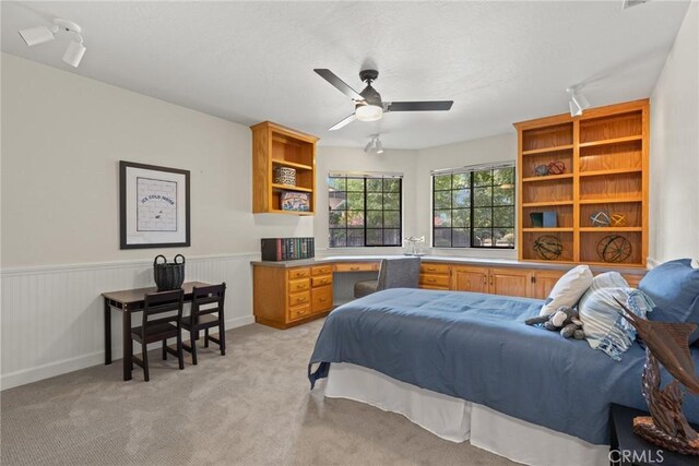 650 Crimson Ct, Chico, CA 95973 - bedroom featuring rail lighting, light colored carpet, a wainscoted wall, and ceiling fan