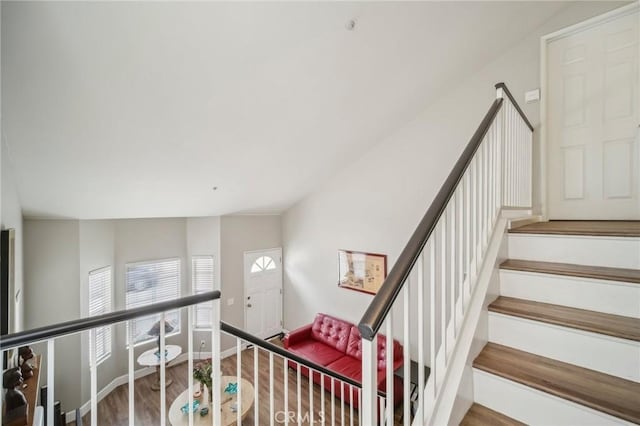 stairway featuring wood finished floors and baseboards