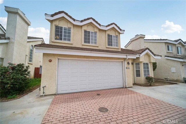 21021 Gault St Unit 9, Canoga Park, CA 91303 - traditional-style house featuring decorative driveway, stucco siding, and a garage